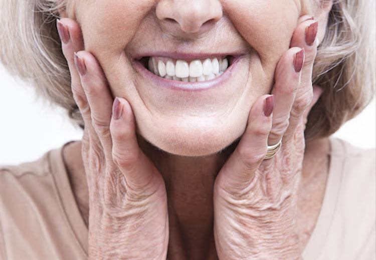 middle age woman with hands on jaw