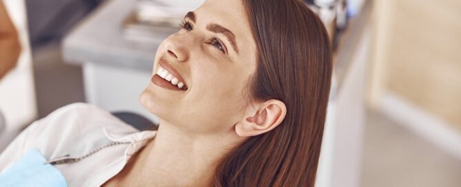 women with dental bib on smiling