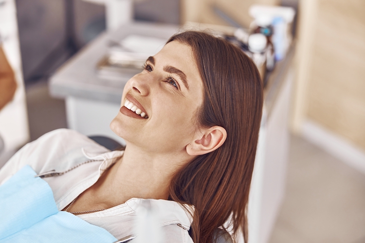 women with dental bib on smiling
