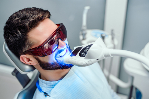 Male getting teeth whitened