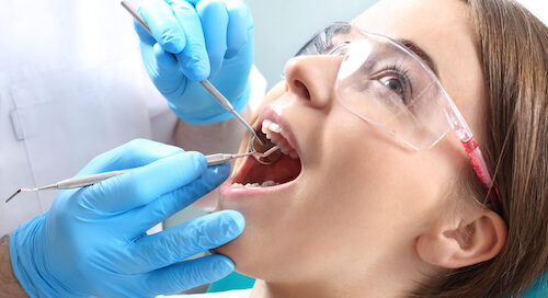 Dentist Performing Procedure on Patient