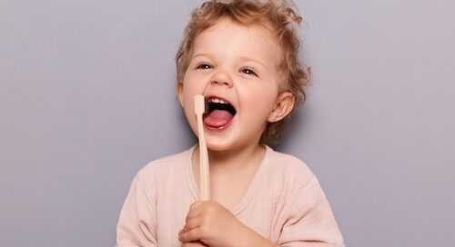 Laughing Happy Girl Brushing Her Teeth