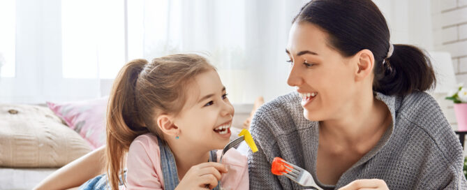 mother and daughter eating salad together