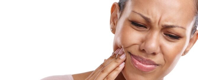 woman grabbing at her jaw
