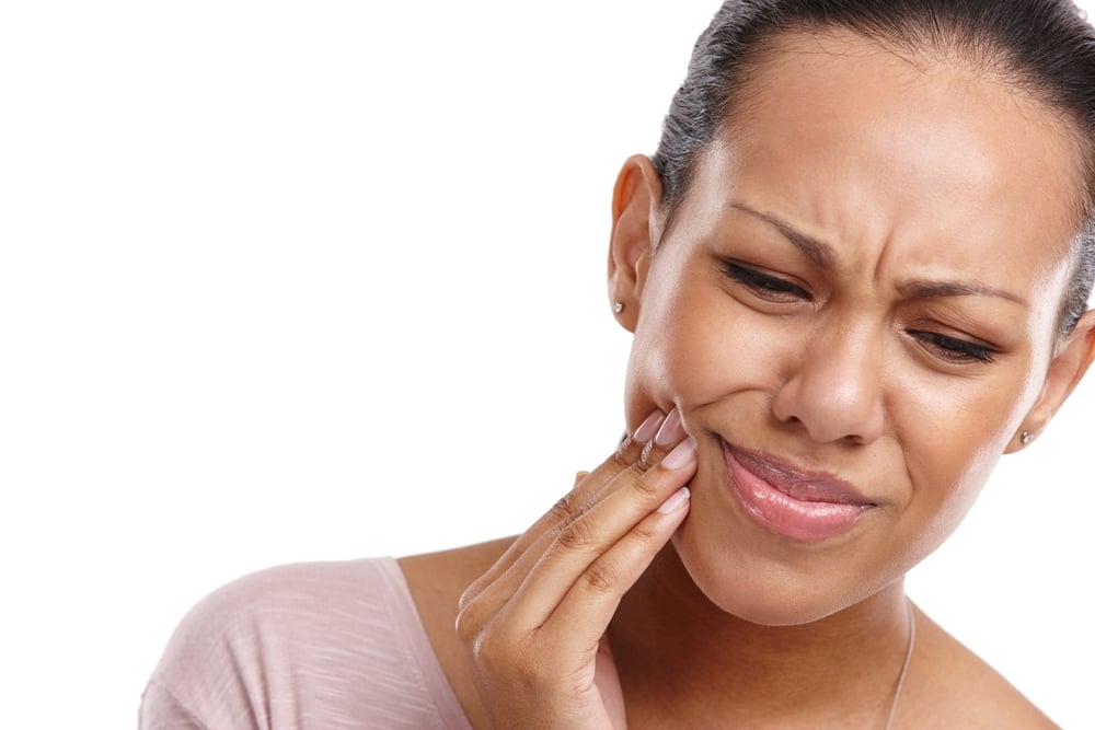 woman grabbing at her jaw