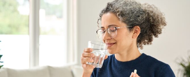 woman taking vitamins for gun health