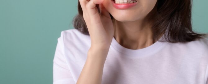 Woman with a toothache holding cheek