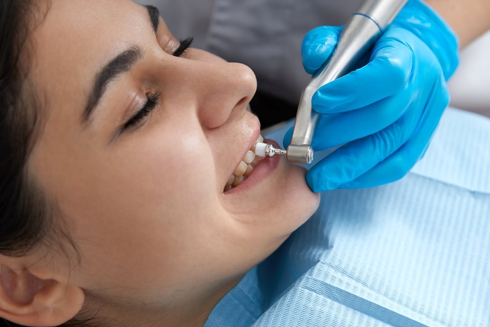 young woman getting her teeth cleaned